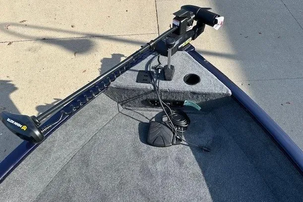 Slide: The Image of 2025 Tracker Pro Guide V-175 Combo boat with trolling motor on carpeted deck. - 3