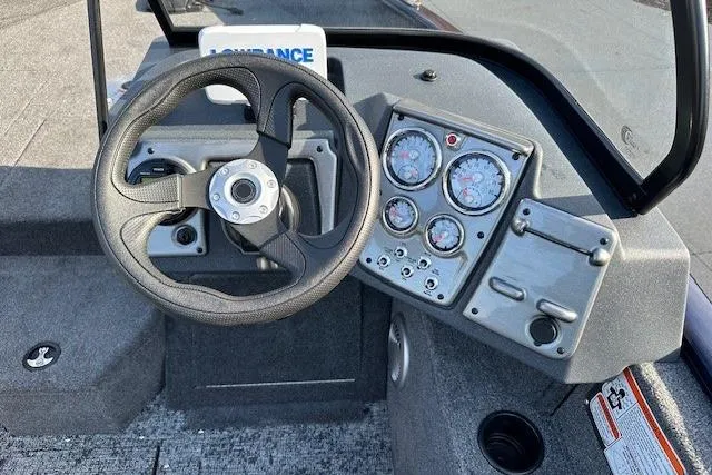 Slide: The Image of 2025 Tracker Pro Guide V-175 Combo boat dashboard with steering wheel and gauges. - 6