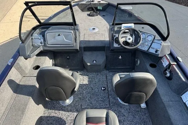 Slide: The Image of 2025 Tracker Pro Guide V-175 Combo boat interior with dual seats and dashboard view. - 7