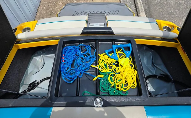 Slide: The Image of Storage compartment of 2015 Malibu Wakesetter 22 VLX with colorful ropes and handles. - 6