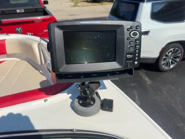 Slide: The Image of Fishfinder on 2018 Chaparral 21 H2O Ski & Fish boat, parked with vehicles nearby. - 11
