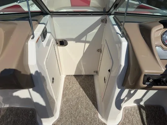 Slide: The Image of 2018 Chaparral 21 H2O Ski & Fish boat interior with open storage compartments. - 13