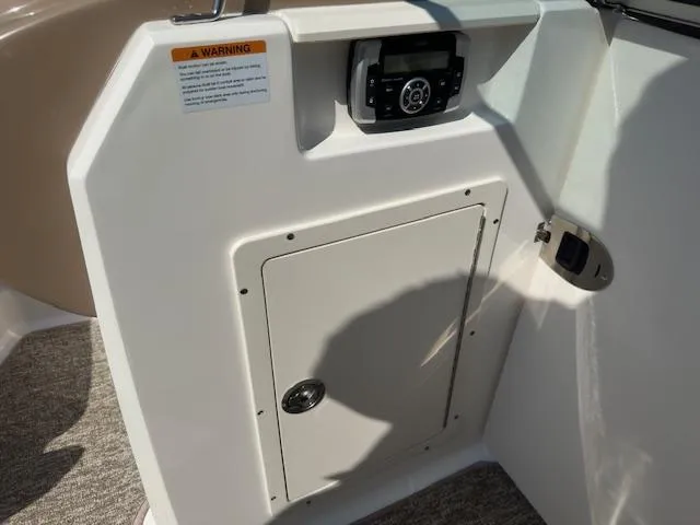 Slide: The Image of 2018 Chaparral 21 H2O Ski & Fish boat console with storage compartment and control panel. - 14