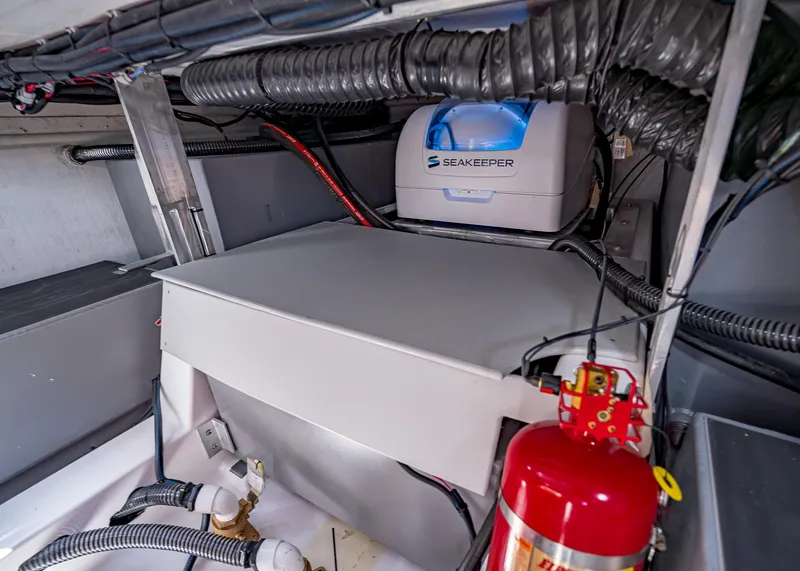 Slide: The Image of Engine compartment of 2025 Paradigm Damascus 266 Surf with Seakeeper stabilizer and fire extinguisher. - 20