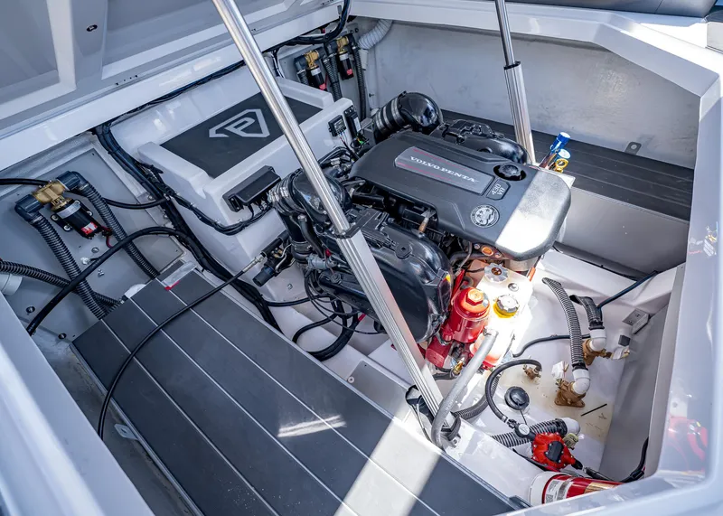 Slide: The Image of Engine compartment of 2025 Paradigm Damascus 266 Surf boat, featuring Volvo Penta engine. - 21