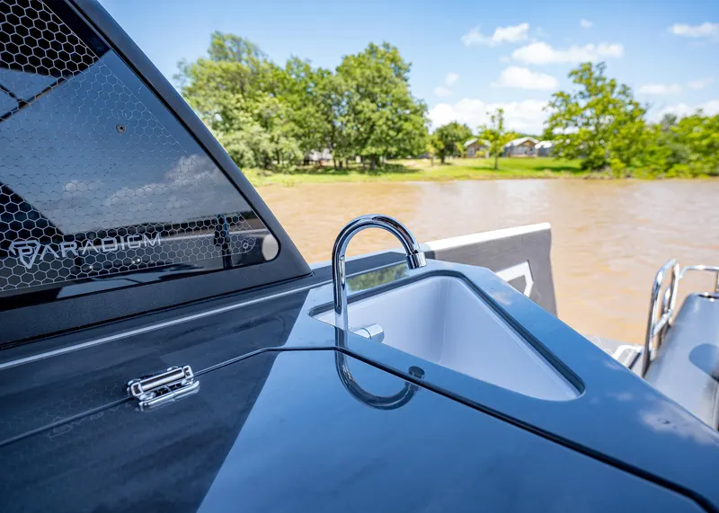 Slide: The Image of 2025 Paradigm Damascus 266 Surf boat with sleek design and outdoor sink. - 24