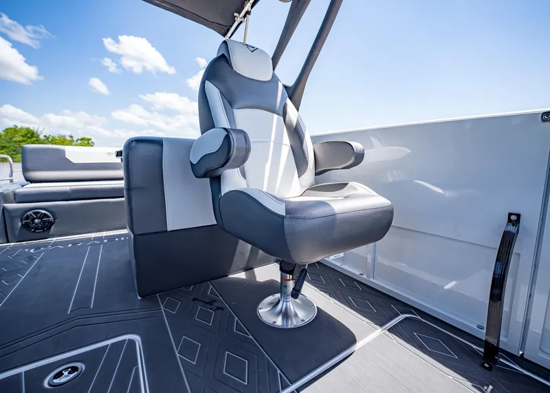 Slide: The Image of Captain's chair on 2025 Paradigm Damascus 266 Surf boat, under clear blue sky. - 28