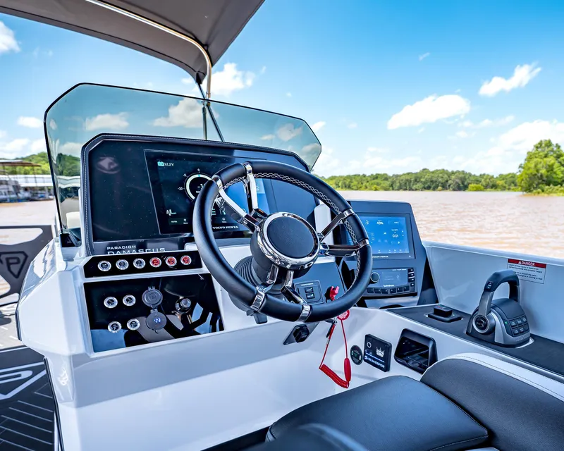 Slide: The Image of 2025 Paradigm Damascus 266 Surf boat dashboard with modern controls and steering wheel. - 31