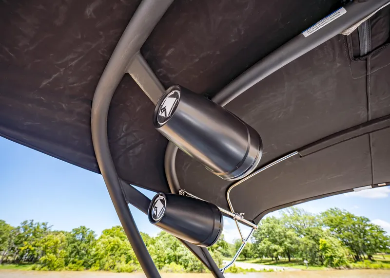 Slide: The Image of 2025 Paradigm Damascus 266 Surf boat speakers under canopy, outdoor setting. - 33