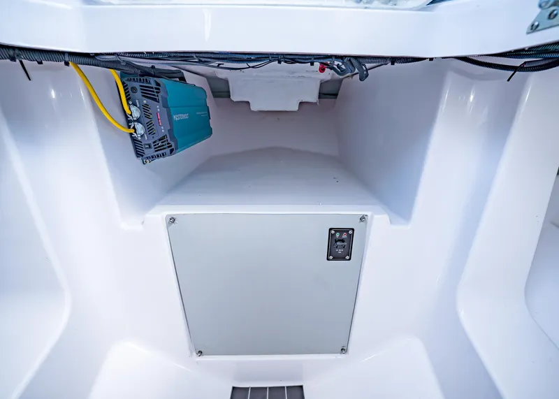 Slide: The Image of Interior view of 2025 Paradigm Damascus 266 Surf boat's storage compartment with electrical components. - 39