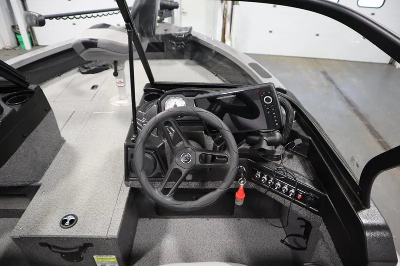 Slide: The Image of 2024 Crestliner 1950 Fish Hawk WT boat interior with steering wheel and control panel. - 32