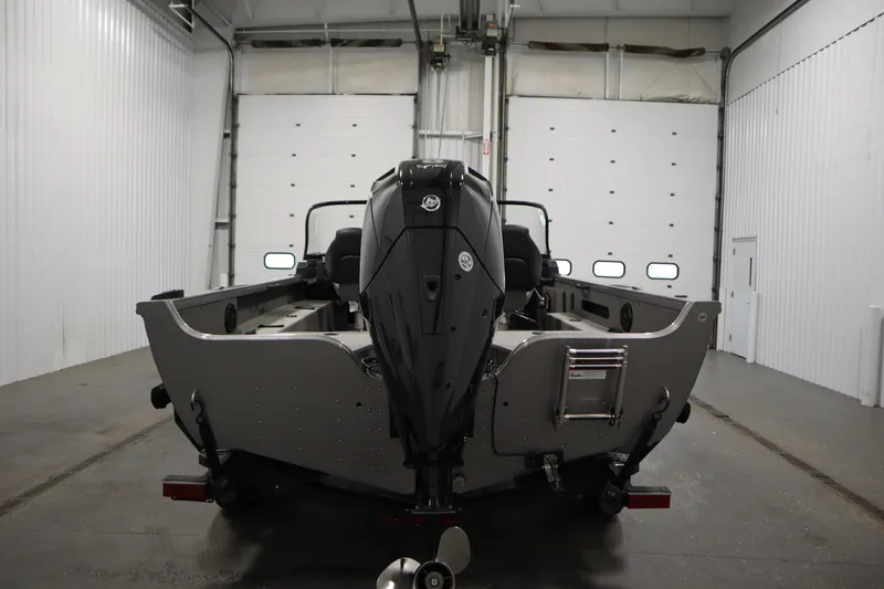 Slide: The Image of 2024 Crestliner 1950 Fish Hawk WT boat in a garage, rear view. - 6