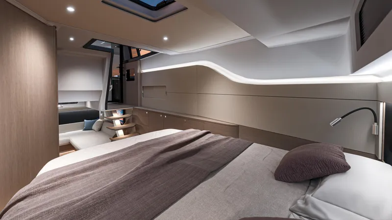 Slide: The Image of Luxurious interior of 2026 Beneteau Gran Turismo 40 yacht, featuring modern design and cozy bedding. - 12