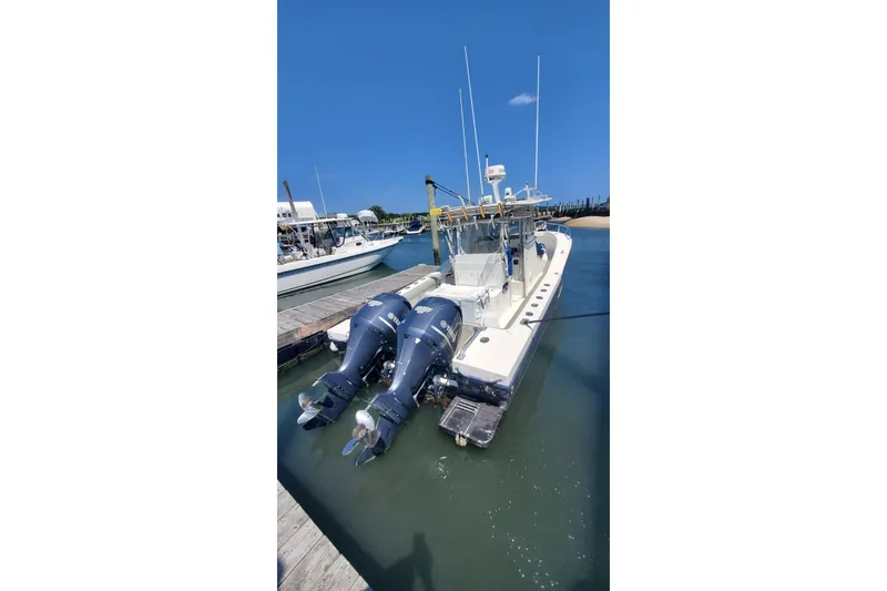 Slide: The Image of 1998 Ocean Master 31 Center Console boat docked with dual outboard engines. - 11