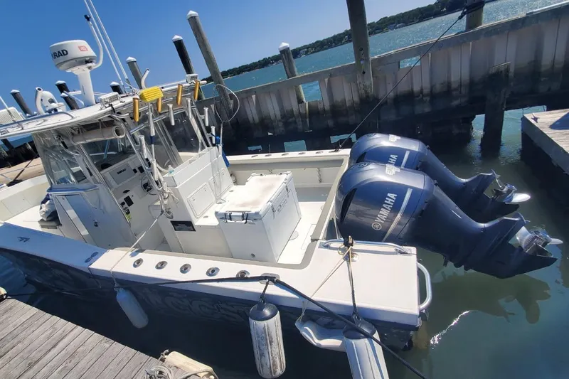 Slide: The Image of 1998 Ocean Master 31 Center Console boat docked with twin Yamaha outboard engines. - 15