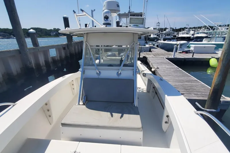 Slide: The Image of 1998 Ocean Master 31 Center Console boat docked at marina on a sunny day. - 16