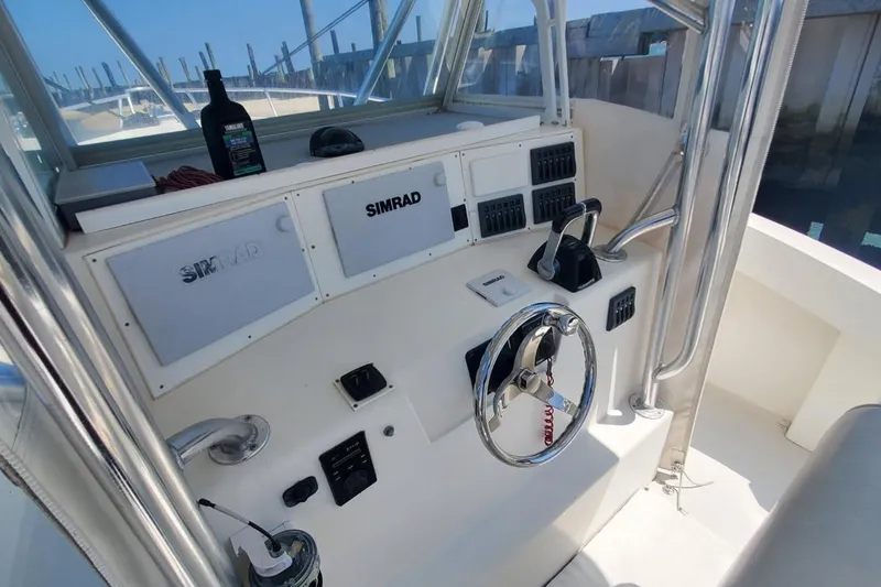 Slide: The Image of 1998 Ocean Master 31 Center Console helm with Simrad electronics and steering wheel. - 27