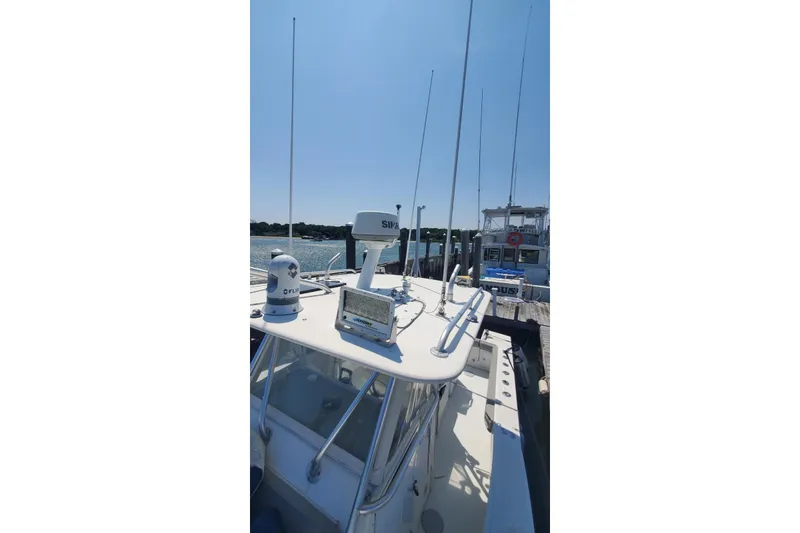 Slide: The Image of 1998 Ocean Master 31 Center Console boat with radar and antennas at dock. - 30