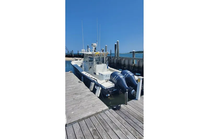 Slide: The Image of 1998 Ocean Master 31 Center Console boat docked at a marina. - 5