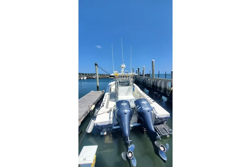 Slide: The Image of 1998 Ocean Master 31 Center Console boat docked with twin outboard engines. - 8