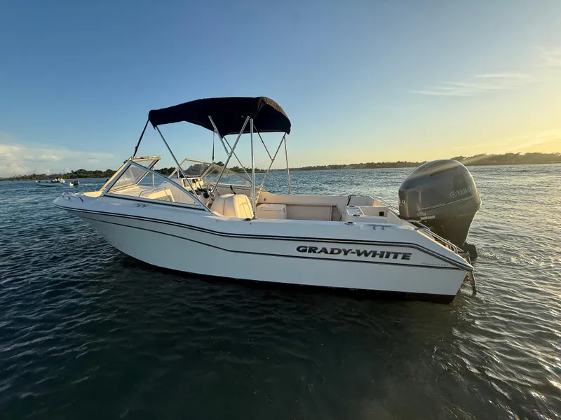 Slide: The Image of 2020 Grady-White Freedom 192 boat on water at sunset, featuring a Yamaha outboard motor. - 10