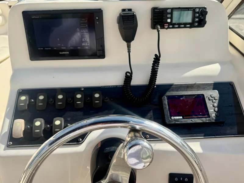 Slide: The Image of Control panel of 2020 Grady-White Freedom 192 boat with Garmin and Yamaha displays. - 13