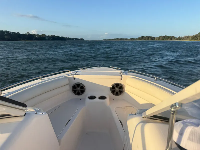 Slide: The Image of 2020 Grady-White Freedom 192 boat on open water, featuring spacious seating and clear skies. - 14