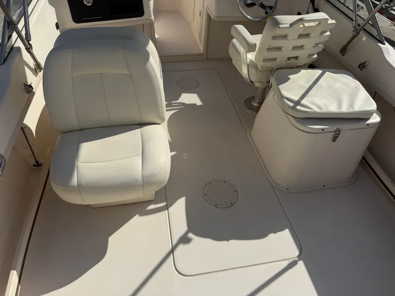 Slide: The Image of 2020 Grady-White Freedom 192 boat interior with white seating and steering area. - 16