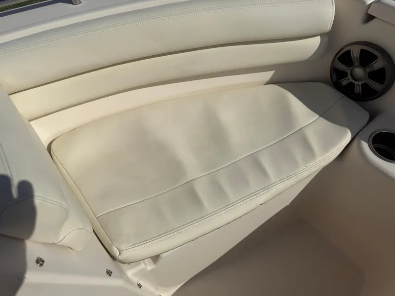 Slide: The Image of 2020 Grady-White Freedom 192 boat interior with white cushioned seating and speaker. - 18