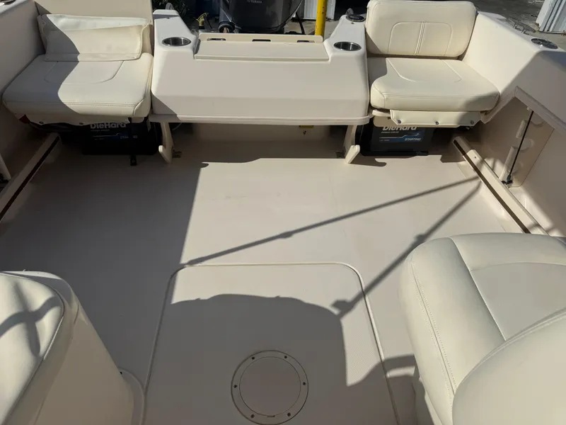 Slide: The Image of 2020 Grady-White Freedom 192 boat interior with cushioned seating and storage compartments. - 21