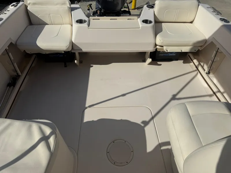 Slide: The Image of 2020 Grady-White Freedom 192 boat interior with cushioned seating and cup holders. - 24