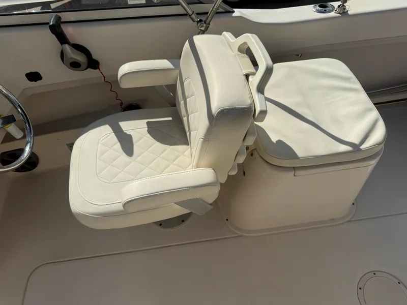 Slide: The Image of Captain's seat on 2020 Grady-White Freedom 192 boat, featuring white cushioned design. - 26