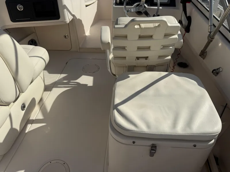 Slide: The Image of Interior of 2020 Grady-White Freedom 192 boat with white seating and steering wheel. - 31