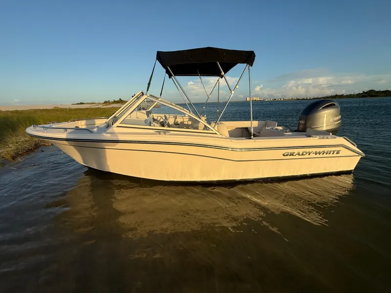 Slide: The Image of 2020 Grady-White Freedom 192 boat on calm water at sunset. - 4