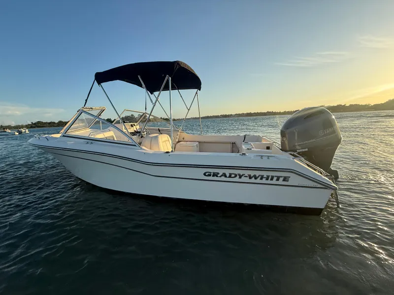 Slide: The Image of 2020 Grady-White Freedom 192 boat on water at sunset, featuring Yamaha outboard motor. - 7