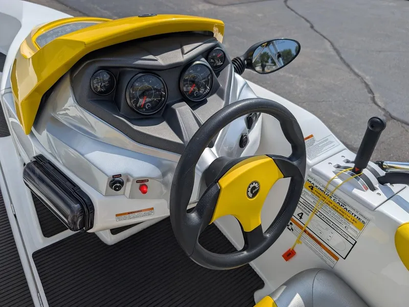 Slide: The Image of 2006 Sea-Doo 150 Sportster dashboard with steering wheel and controls, featuring yellow accents. - 10