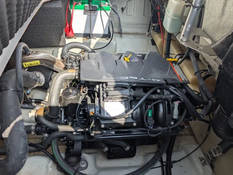 Slide: The Image of Engine compartment of a 2006 Sea-Doo 150 Sportster with visible battery and wiring. - 14
