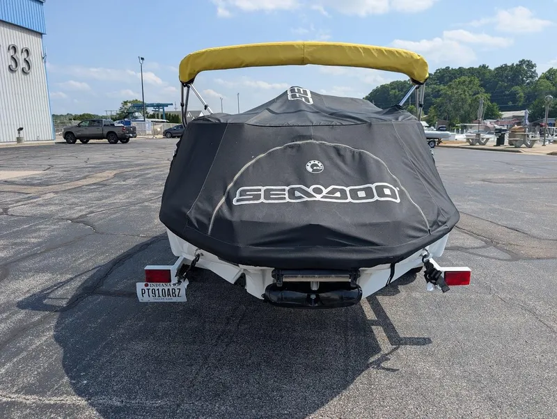 Slide: The Image of 2006 Sea-Doo 150 Sportster with cover, parked outdoors on a sunny day. - 17
