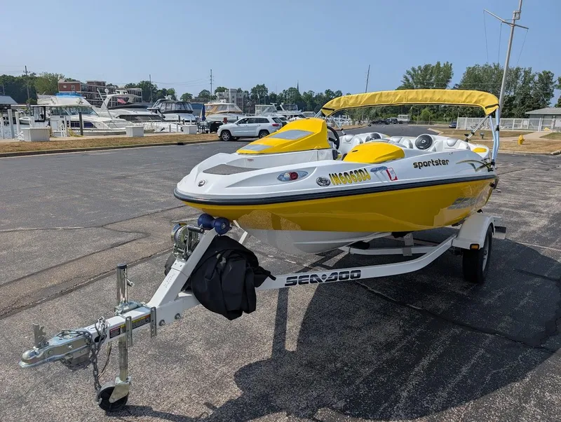 Slide: The Image of 2006 Sea-Doo 150 Sportster boat in yellow, parked on a trailer at a marina. - 3