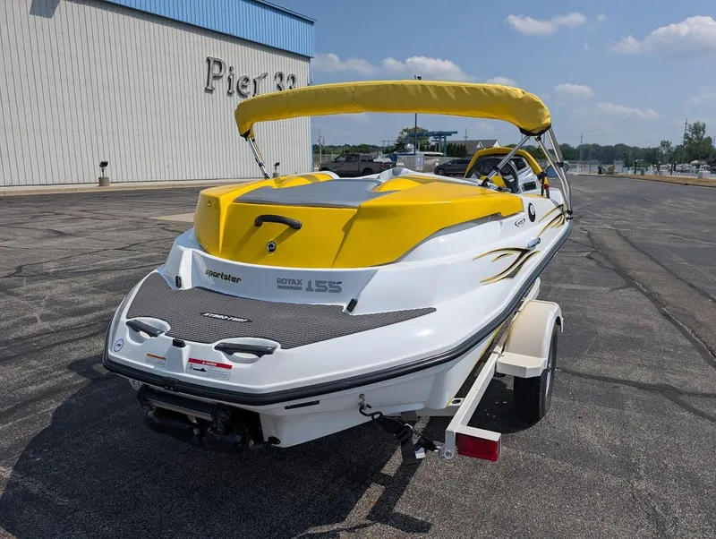 Slide: The Image of 2006 Sea-Doo 150 Sportster boat with yellow accents on a trailer at Pier 33. - 4
