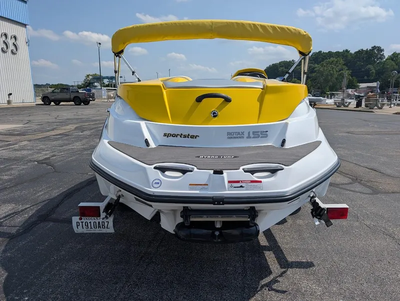 Slide: The Image of 2006 Sea-Doo 150 Sportster boat with yellow accents, parked on a trailer. - 5