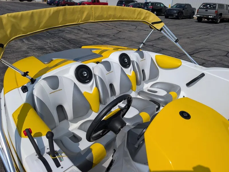 Slide: The Image of 2006 Sea-Doo 150 Sportster interior with yellow and gray seating, steering wheel, and speakers. - 8