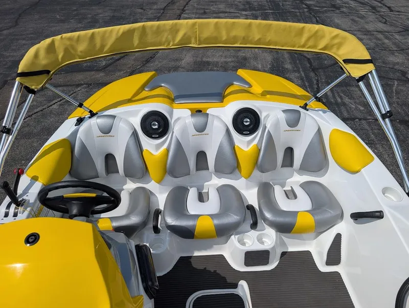 Slide: The Image of 2006 Sea-Doo 150 Sportster interior with yellow and gray seating, steering wheel, and speakers. - 9