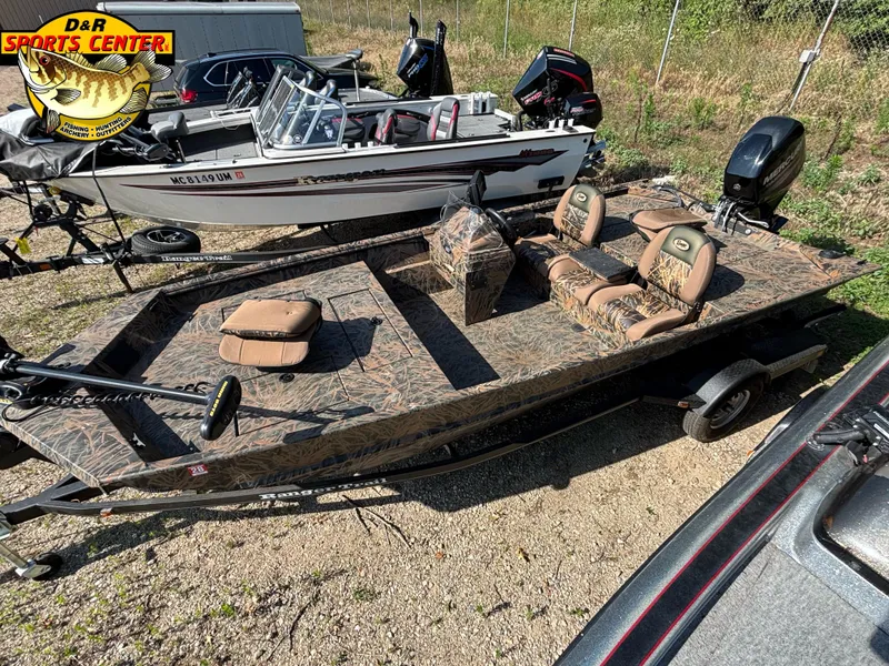 Slide: The Image of 2016 Ranger 1760 MPV camo fishing boat with dual seats and motor, displayed outdoors. - 6