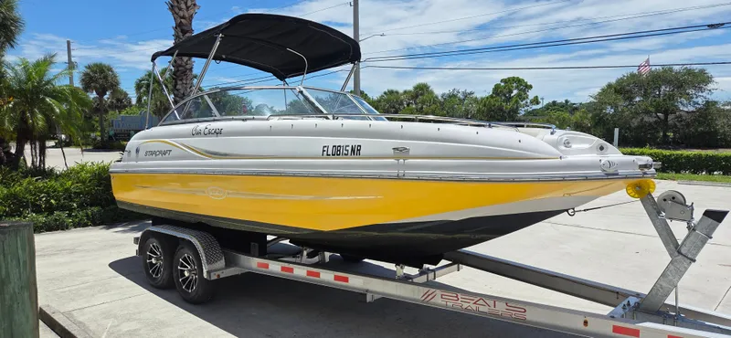 The Image of 2008 Starcraft 2210 OB Limited boat on trailer, yellow and white, parked outdoors. - 0