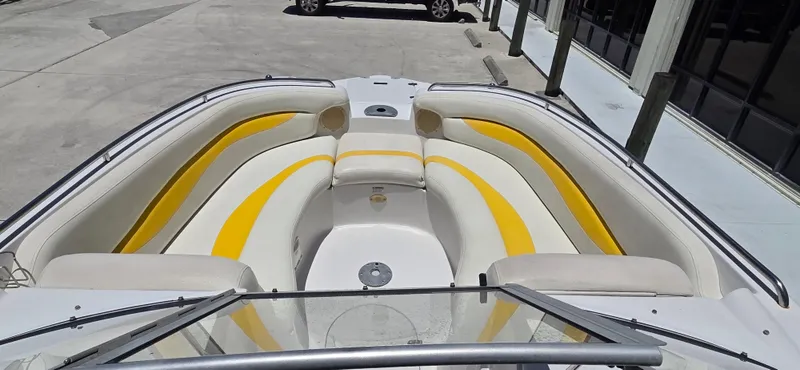 Slide: The Image of 2008 Starcraft 2210 OB Limited boat with yellow and white seating in a marina. - 10