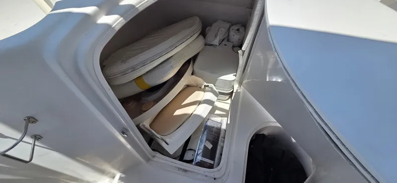 Slide: The Image of Storage compartment in a 2008 Starcraft 2210 OB Limited boat, containing cushions and equipment. - 12