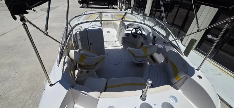 Slide: The Image of 2008 Starcraft 2210 OB Limited boat interior with seating and steering wheel. - 8