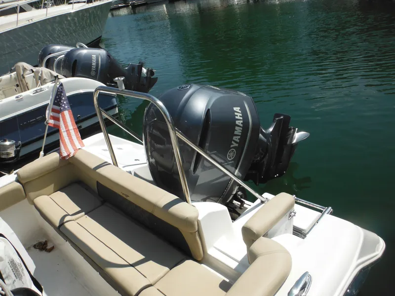 Slide: The Image of 2022 Tidewater 220 LXF boat with Yamaha engines docked in marina. - 10