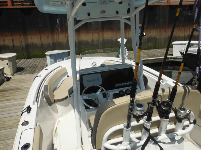 Slide: The Image of 2022 Tidewater 220 LXF boat with fishing rods and Garmin navigation system at dock. - 14